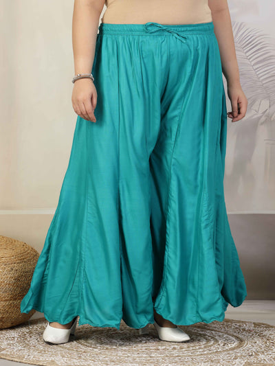 Women solid rama green flared rayon sharara with elasticated waistband and drawstring closure.