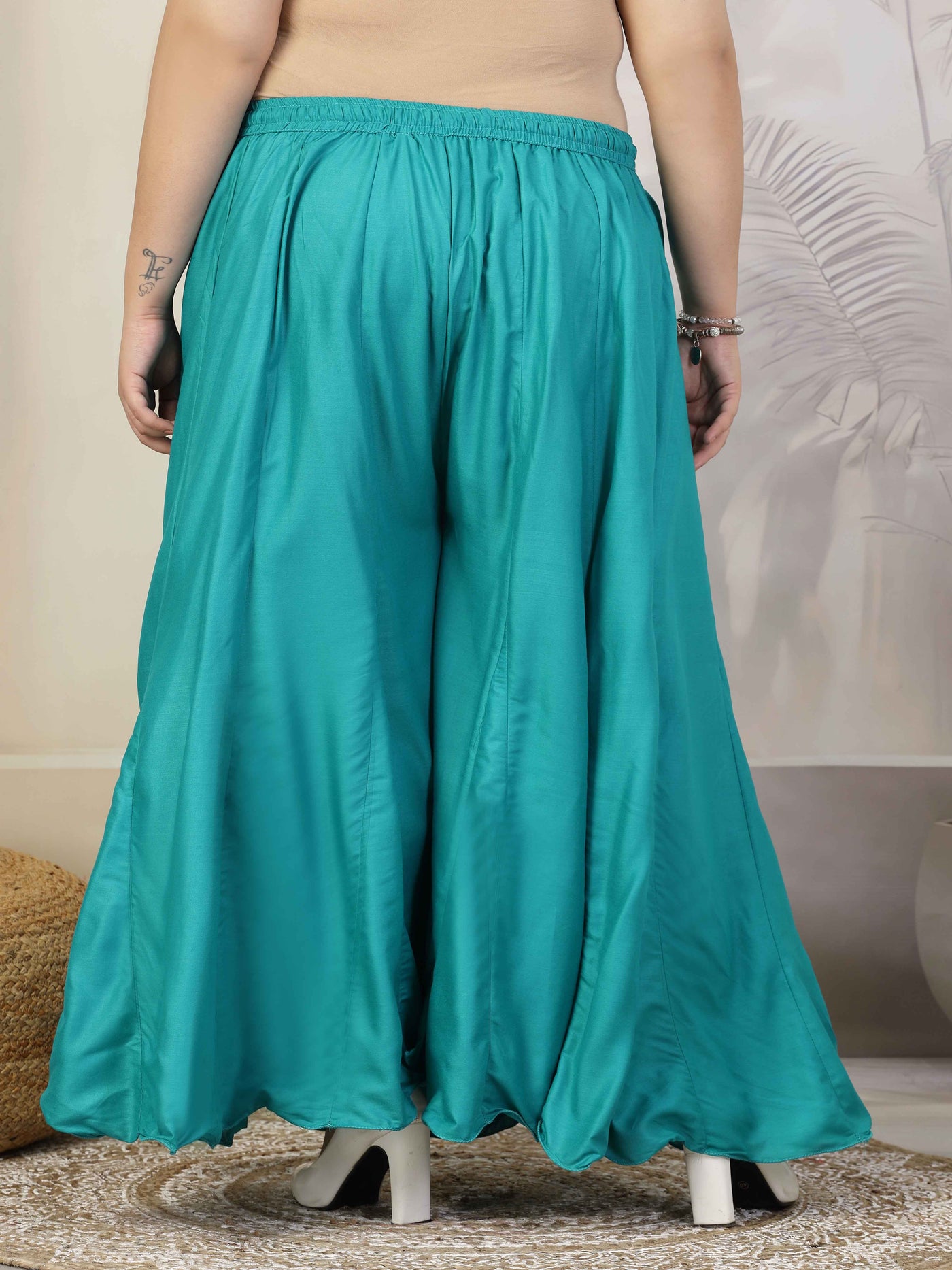 Women solid rama green flared rayon sharara with elastic waistband.