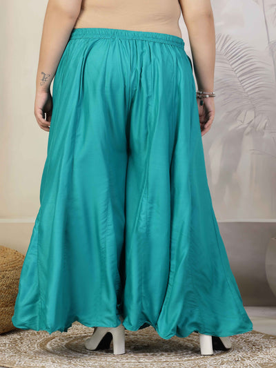 Women solid rama green flared rayon sharara with elastic waistband.