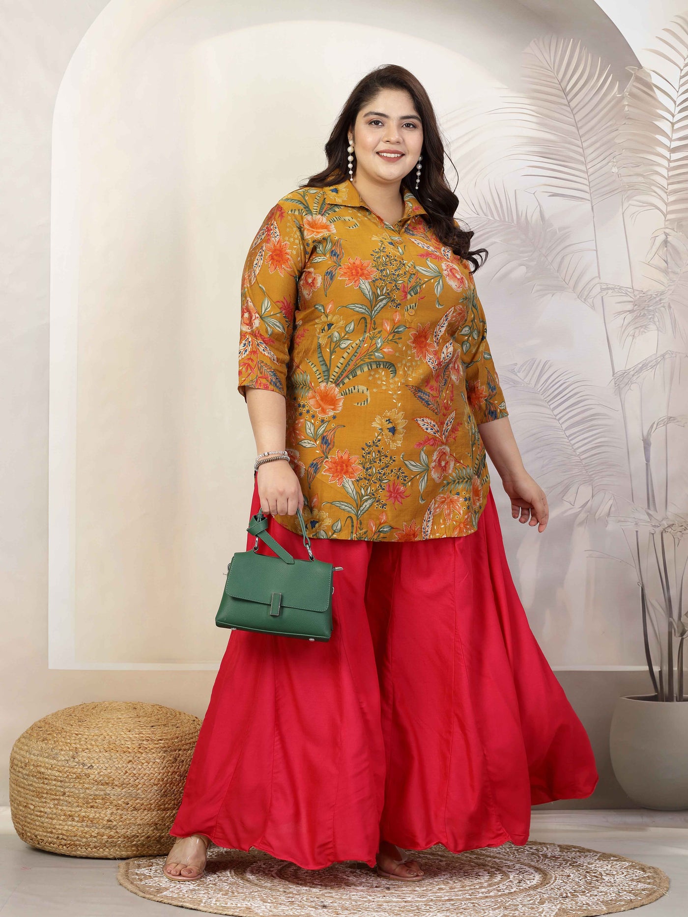 Women Solid Red Flared Rayon Sharara with elasticated waistband and drawstring closure.