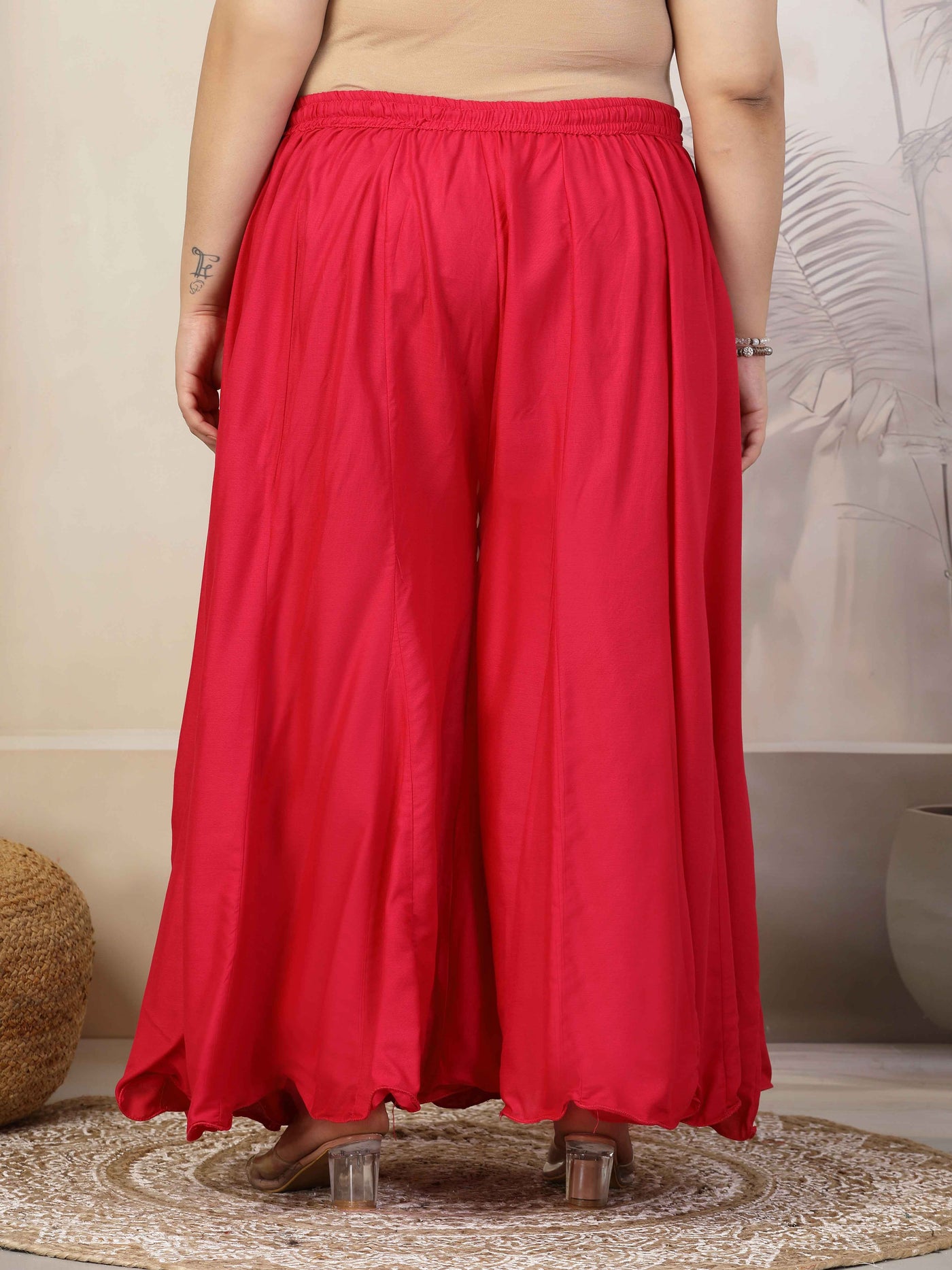 Plus size solid red flared rayon sharara with elasticated waistband and drawstring closure.