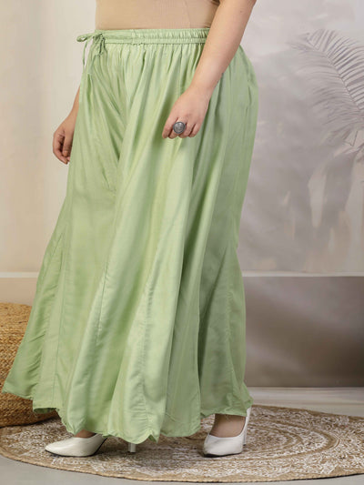 Women solid pista green flared rayon sharara with elasticated waistband and drawstring closure.