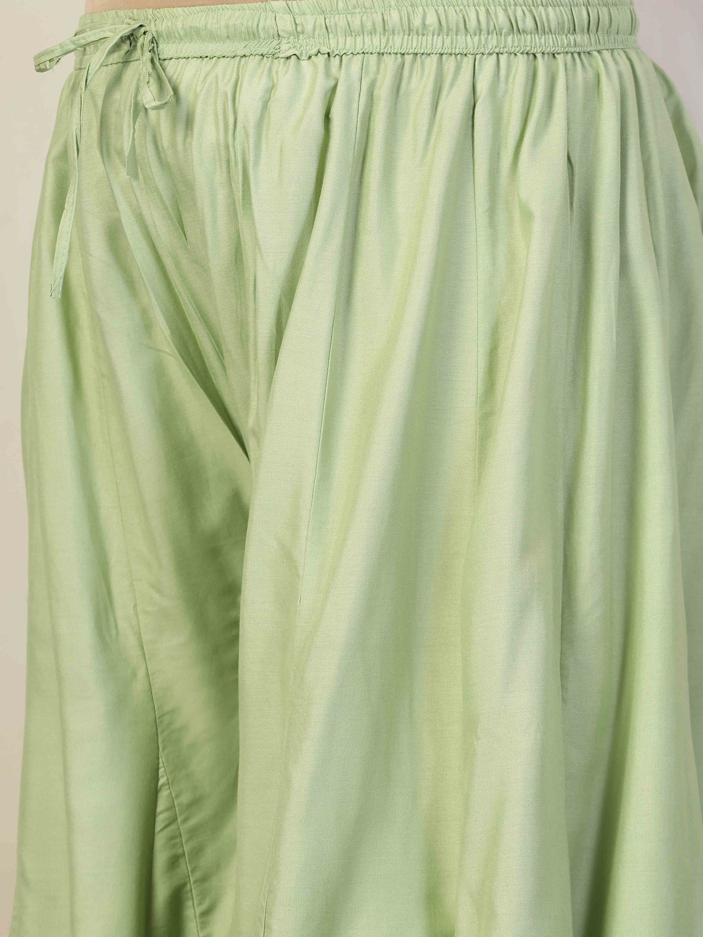 Women solid pista green flared rayon sharara with elasticated waistband and drawstring.