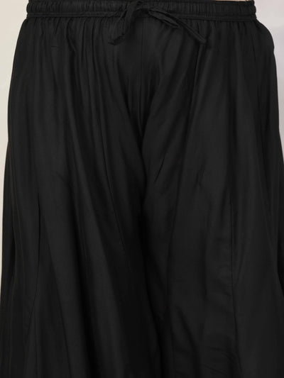 Women solid black flared rayon sharara with elasticated waistband and drawstring closure.