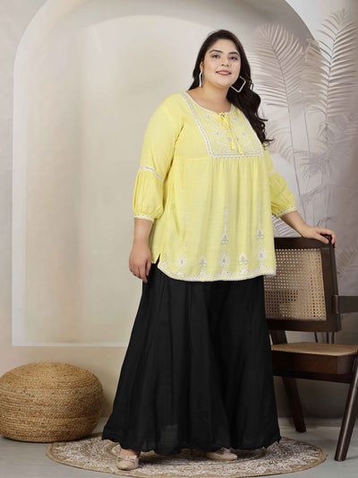 Women wearing solid black flared rayon sharara with elasticated waistband and drawstring closure.