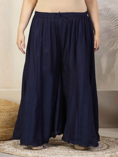 Women solid navy blue flared rayon sharara with elasticated waistband and drawstring closure.