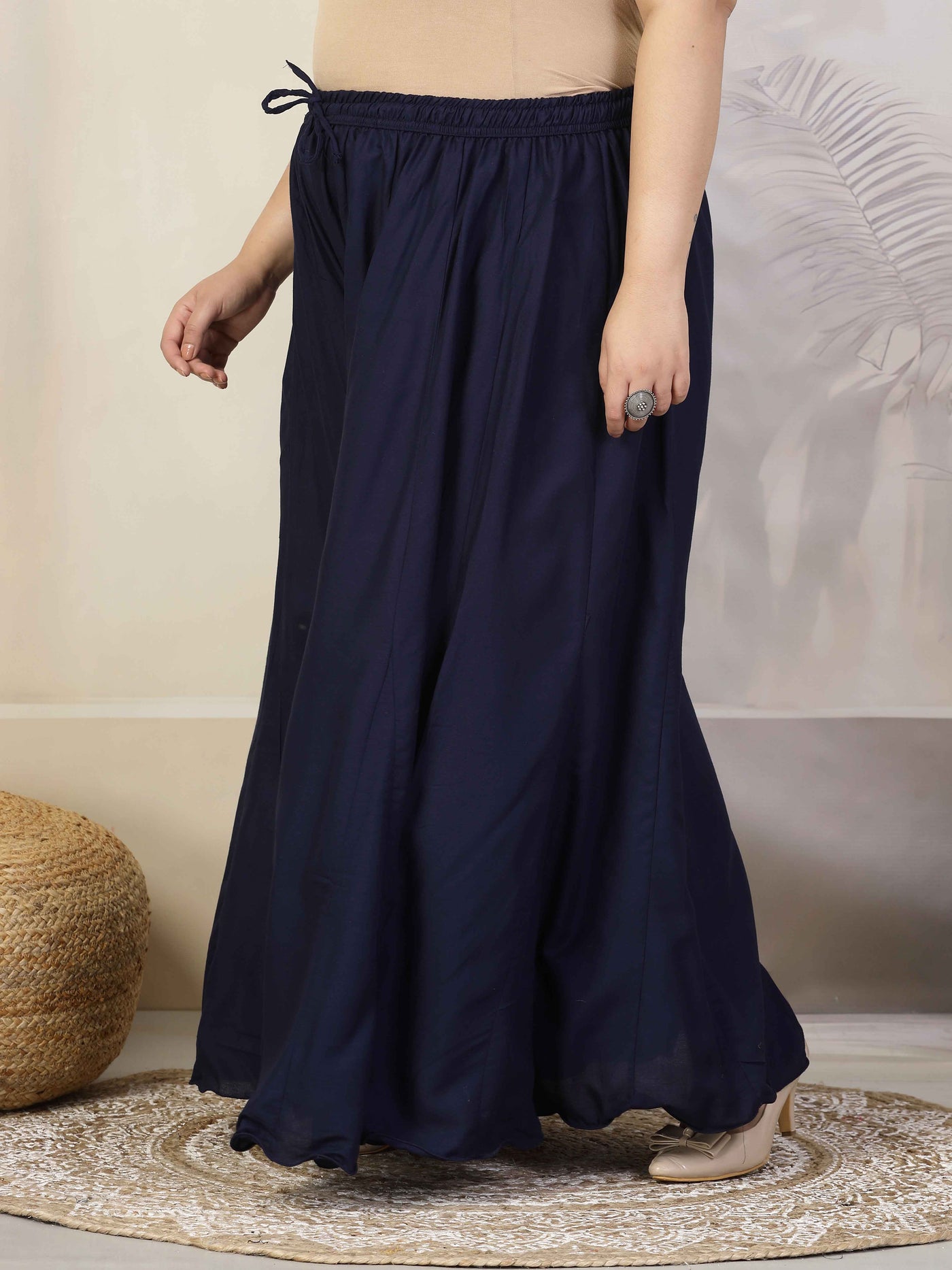 Women solid navy blue flared rayon sharara with elasticated waistband and drawstring closure.