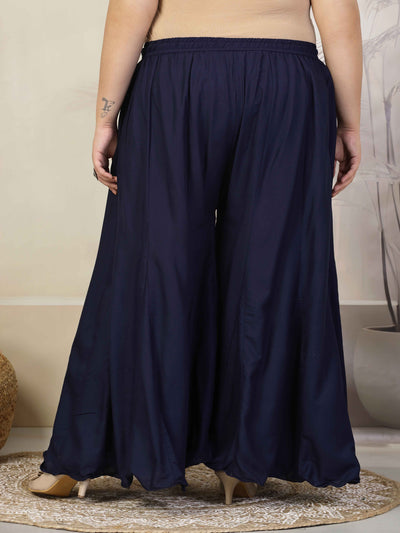 Women solid navy blue flared rayon sharara with elasticated waistband and drawstring closure.