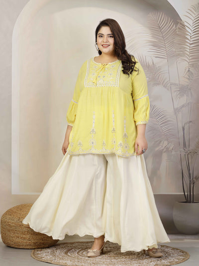 Plus size solid cream flared rayon sharara with elasticated waistband and drawstring closure.