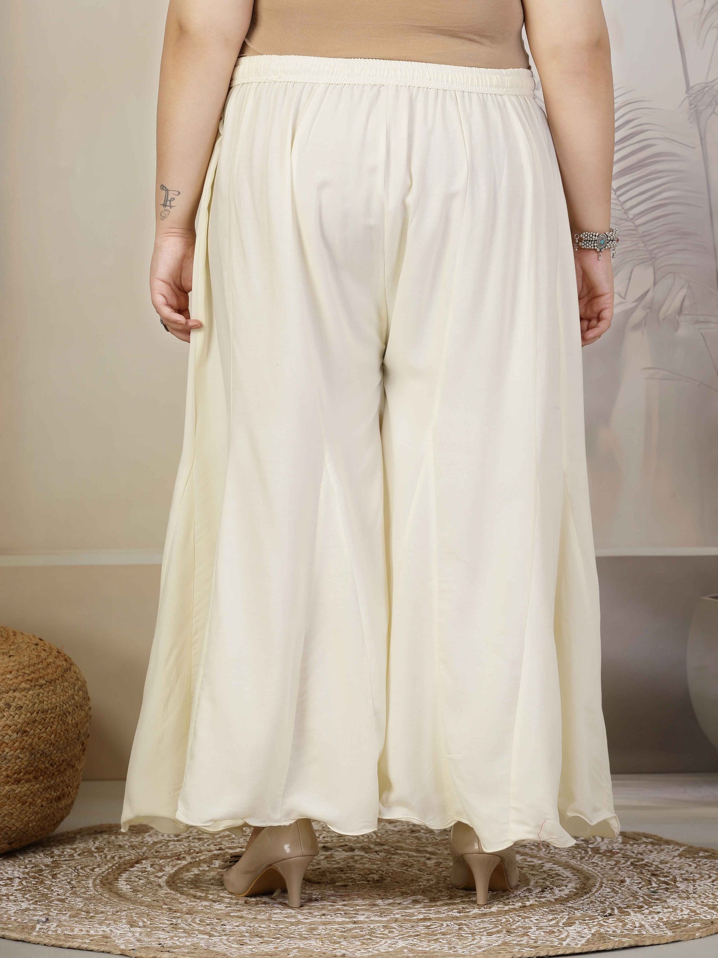 Plus size cream flared rayon sharara with elasticated waistband and drawstring closure.