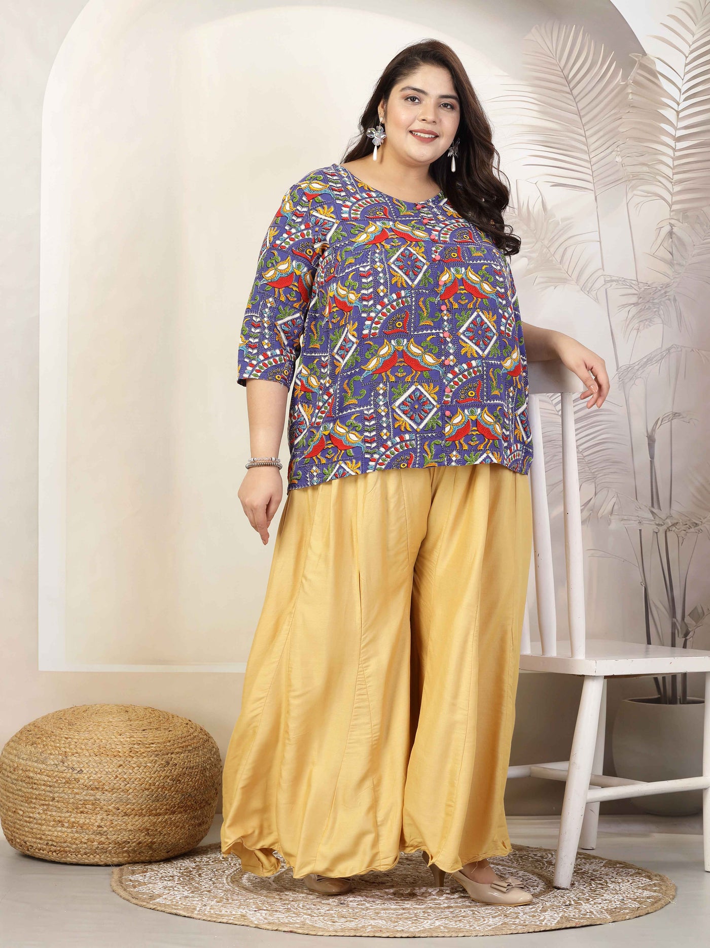 Women wearing a solid fawn flared rayon sharara with elasticated waistband and drawstring closure, paired with a colorful top.