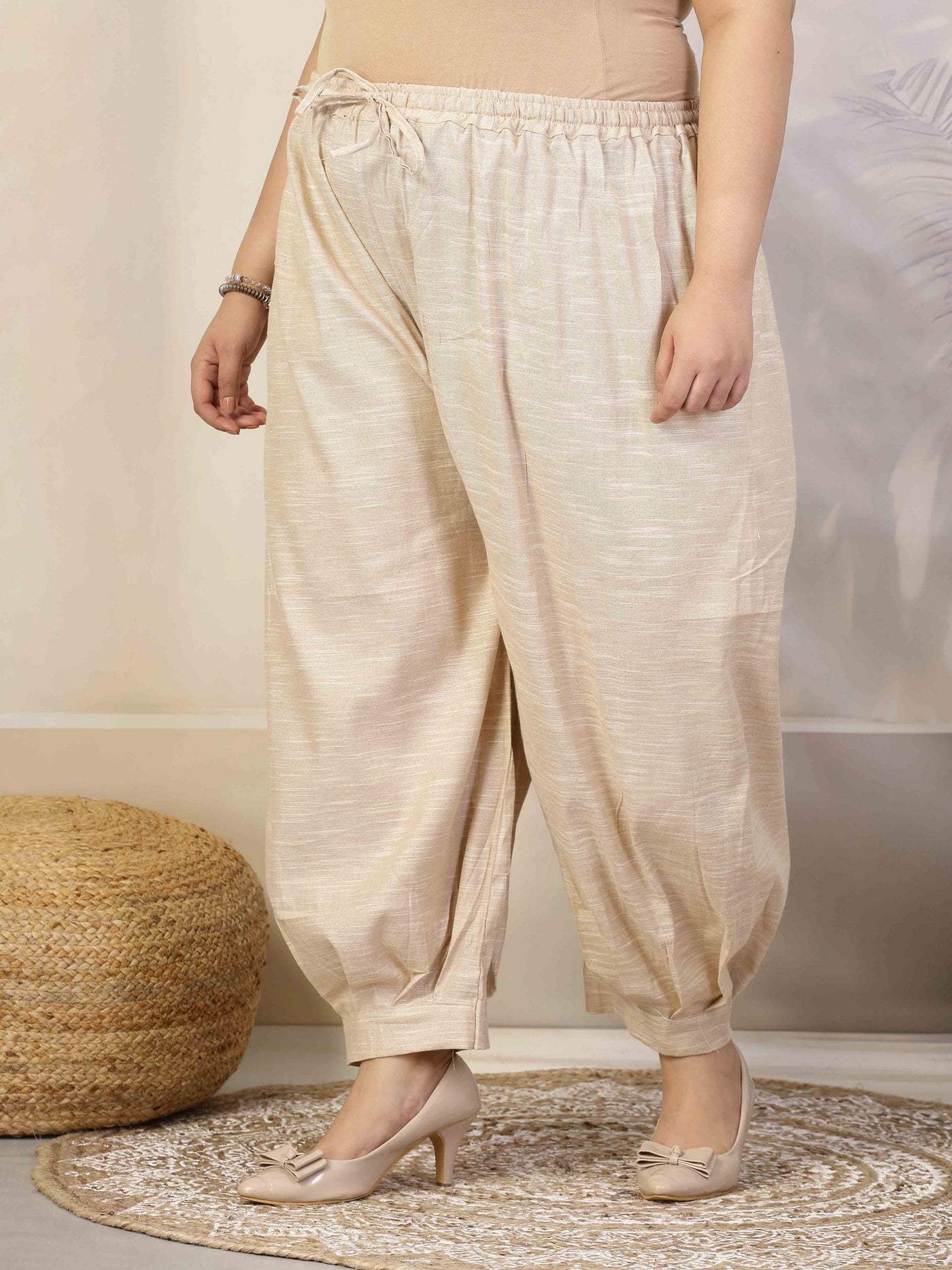 Women solid khadi cotton loose fit Afghani salwar with elasticated waistband and drawstring closure.