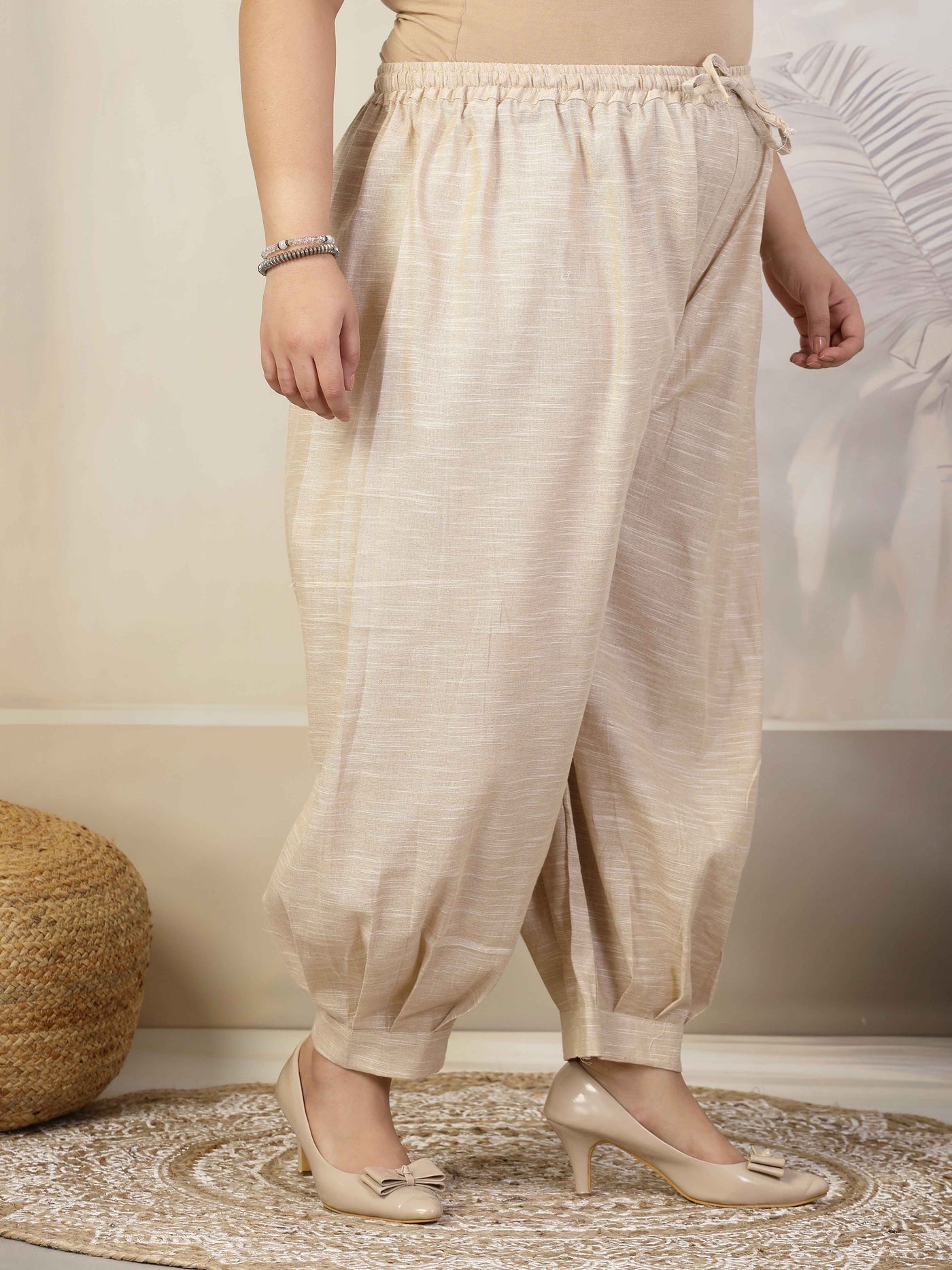 Women wearing solid khadi cotton loose fit Afghani salwar with elasticated waistband and drawstring closure.