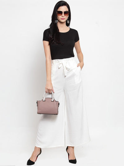 White wide leg solid palazzo with tie knot, styled with a black top and sunglasses.