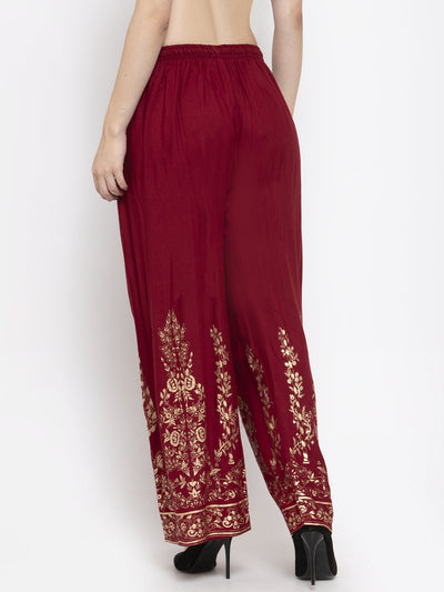 Maroon straight printed rayon palazzo with gold floral designs and elasticated waistband.