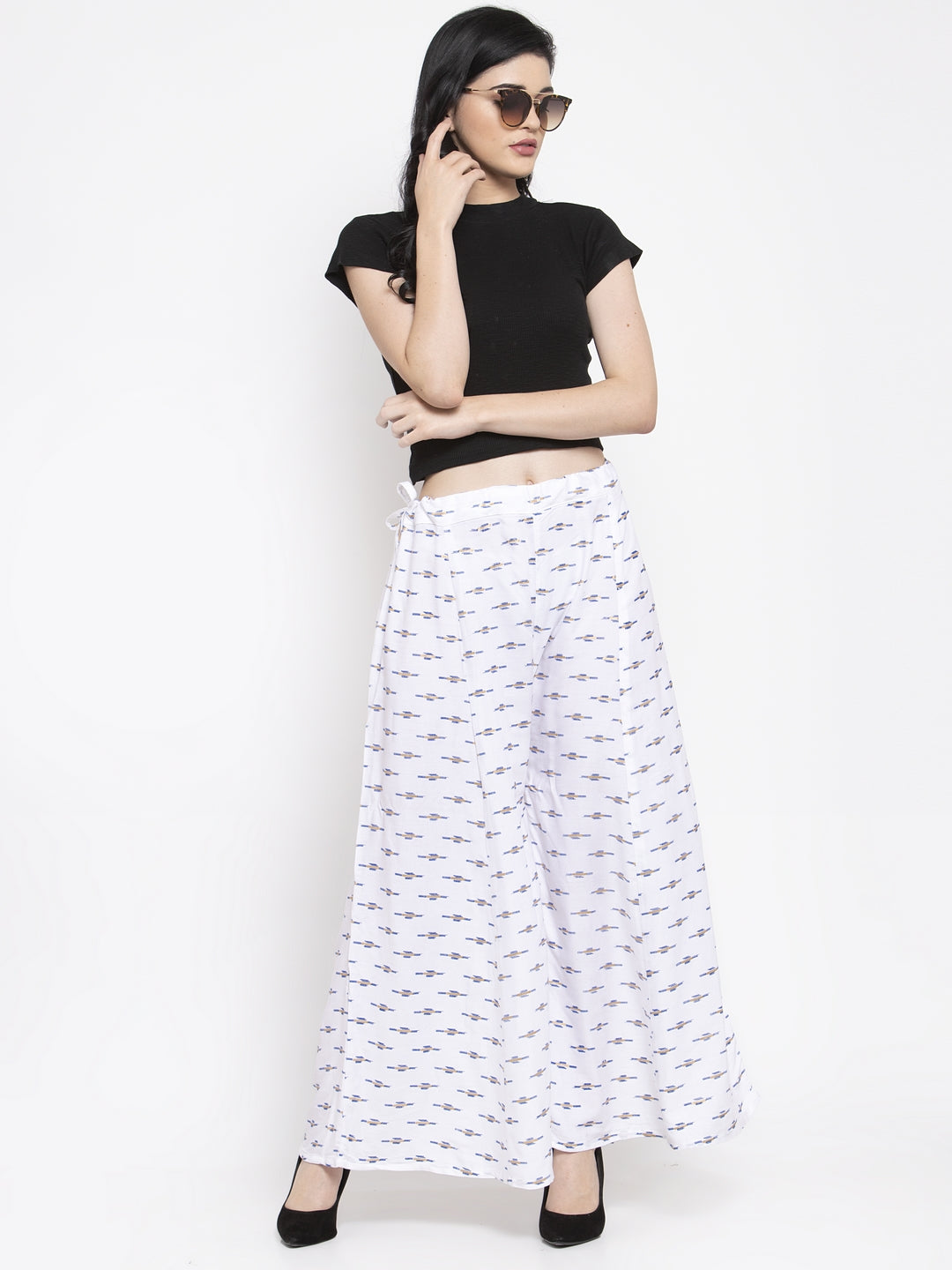 White flared rayon sharara with printed pattern and elasticated waistband.