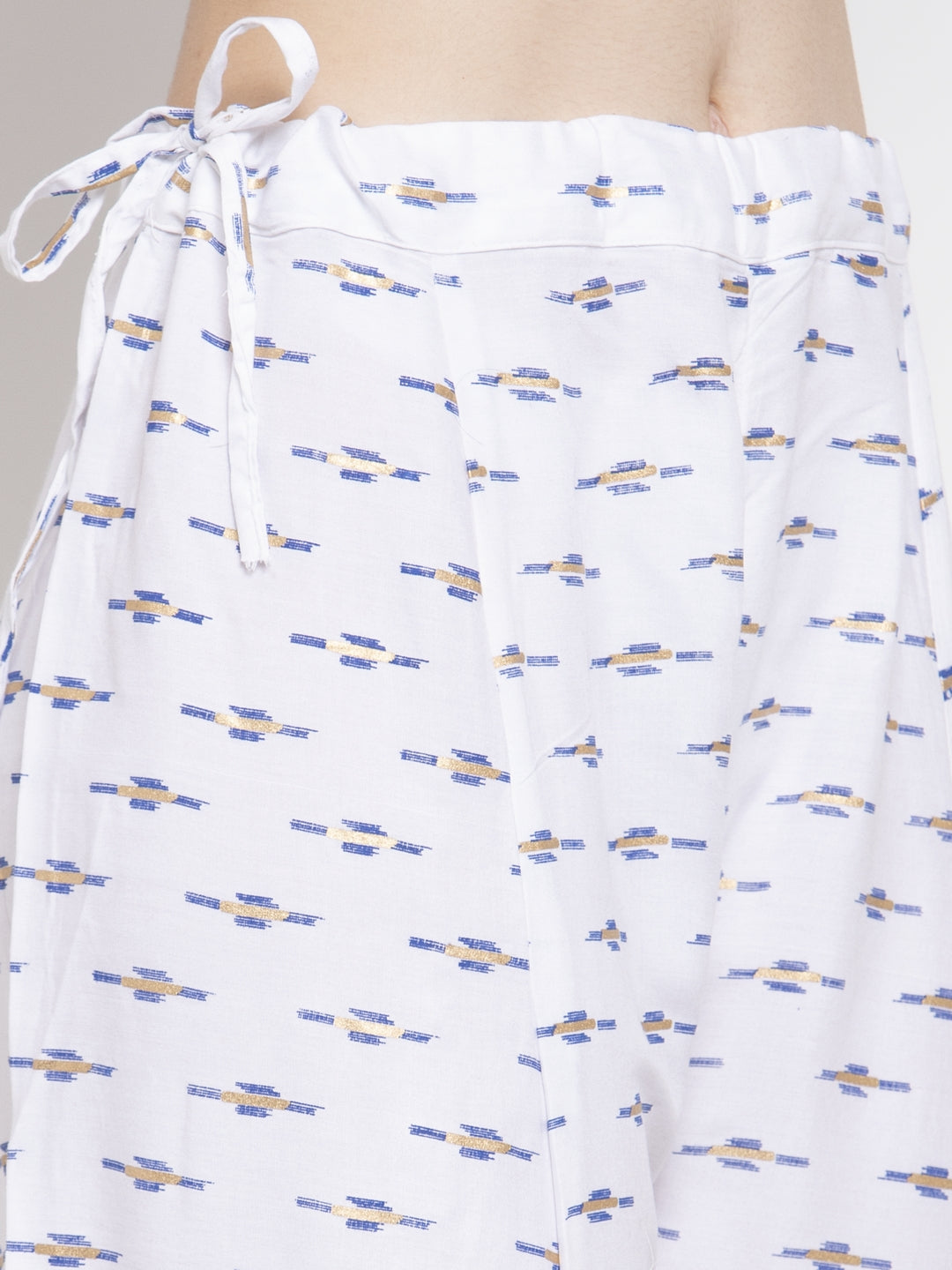 White flared rayon sharara with printed pattern and elasticated waistband.