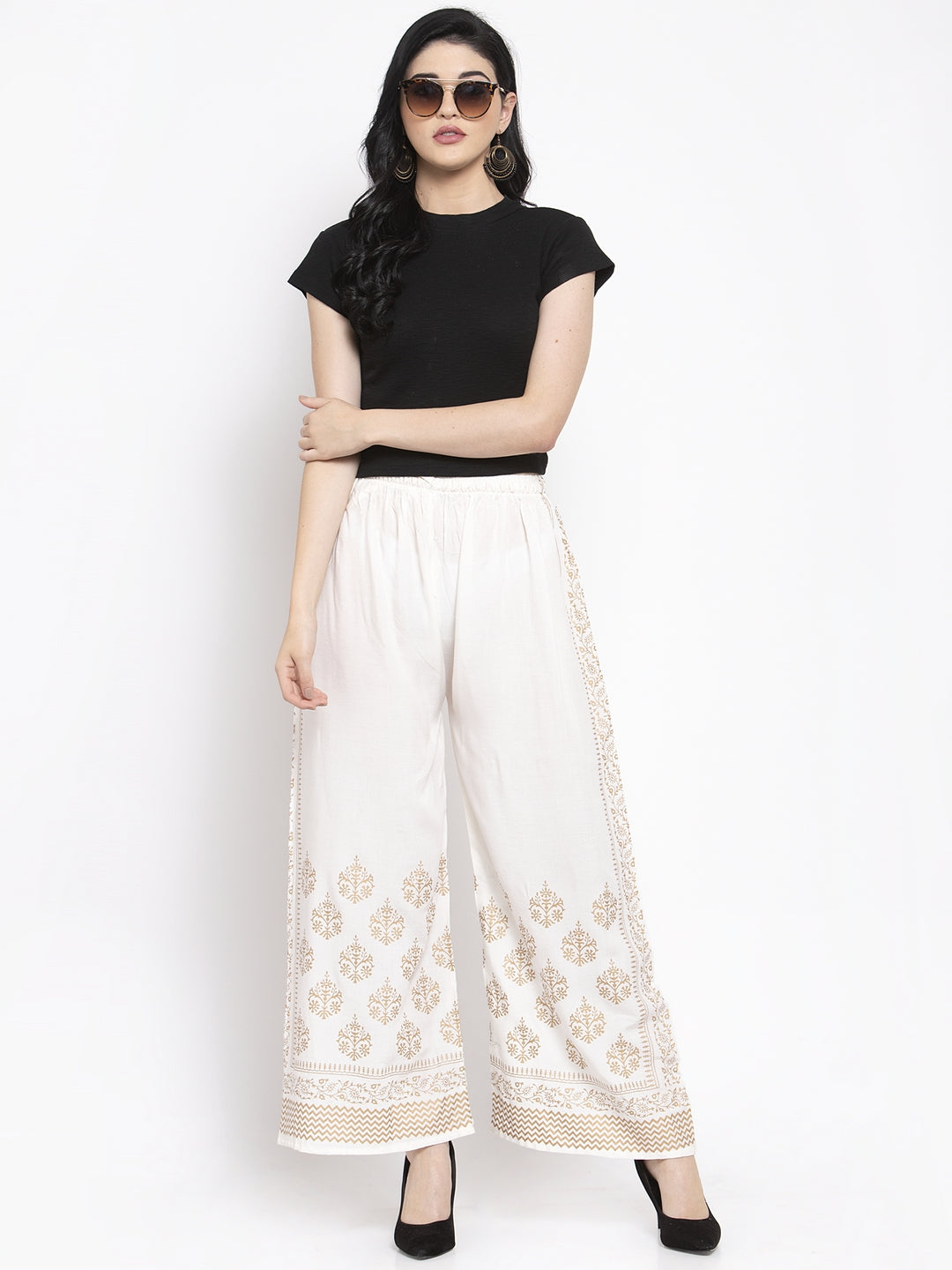 Off-White Rayon Palazzo with printed design and elastic waistband.