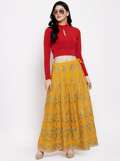 Mustard printed flared rayon maxi skirt for women, styled with a red top.