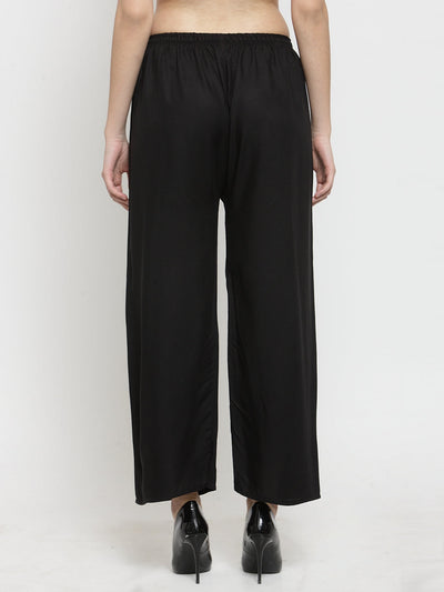 Solid black rayon palazzo trousers for women, back view.