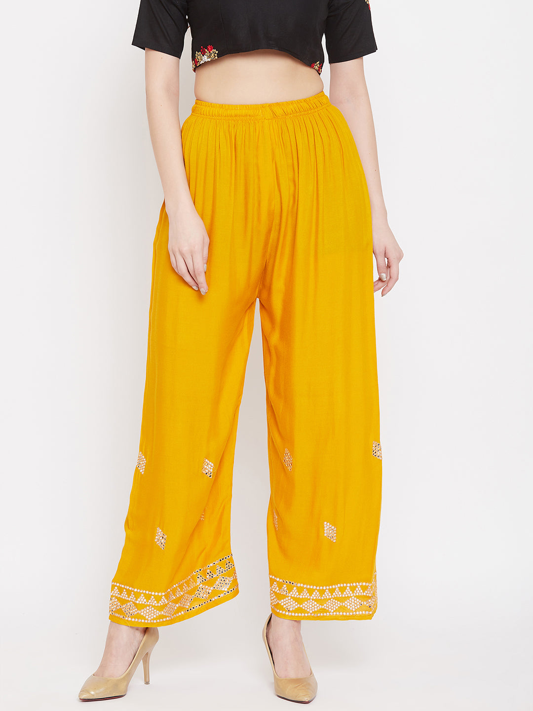 Mustard embellished rayon palazzo with mirror work and elastic waistband.