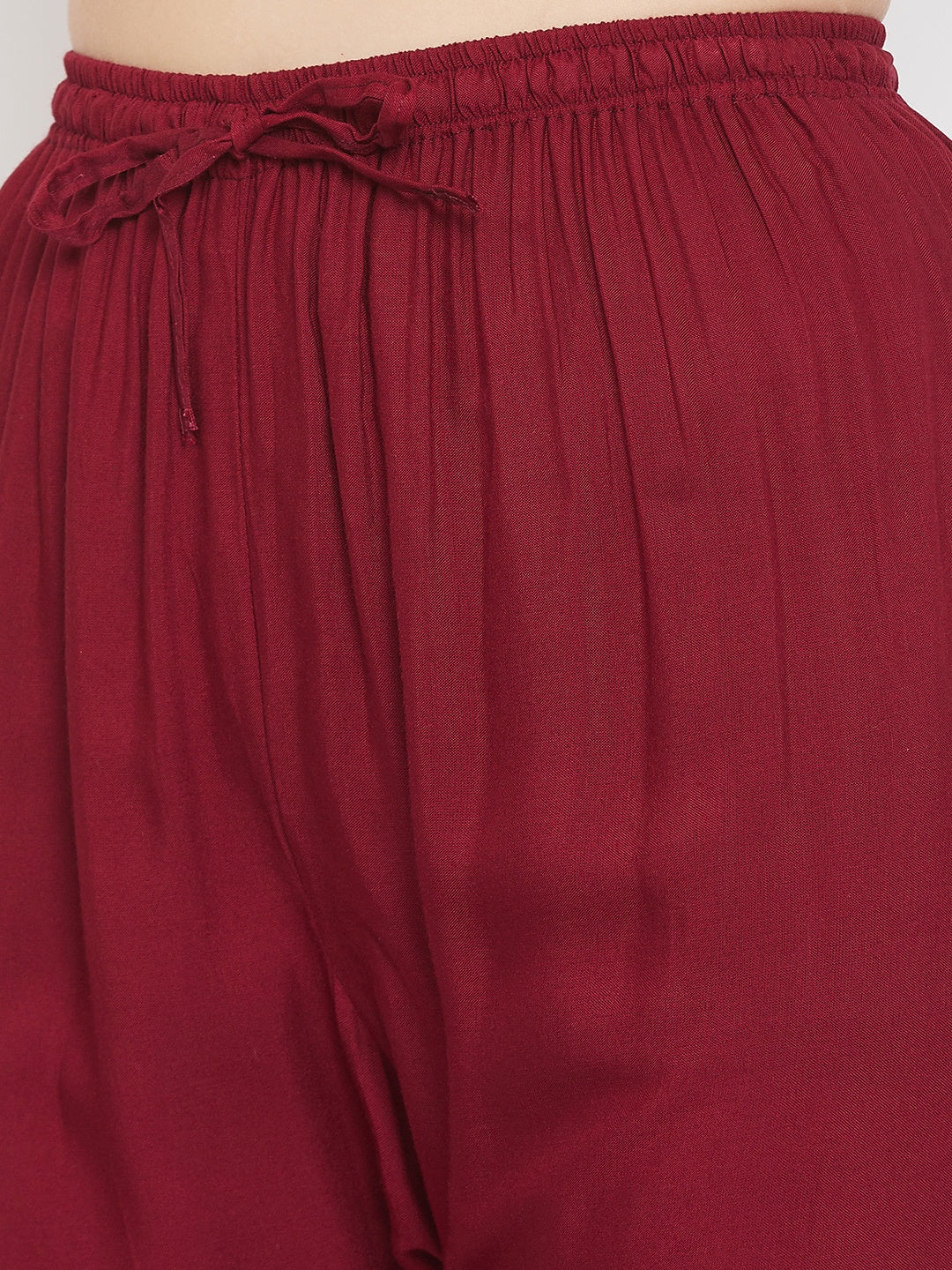 Maroon straight embellished palazzo with elasticated waistband and stone work.