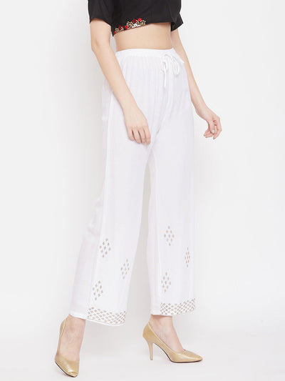 White straight embellished palazzo with elasticated waistband and stone work hem.