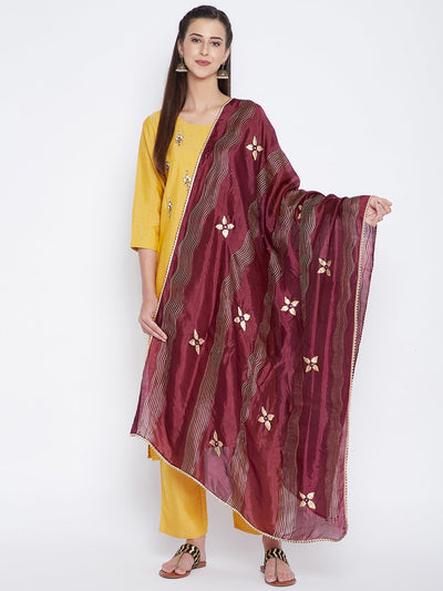 Wine printed silk dupatta with floral design styled over a yellow kurta set.