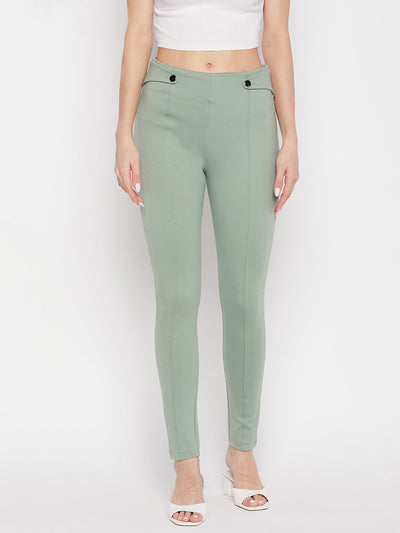 Pista green solid relaxed fit jeggings with elasticated waistband and back pockets.