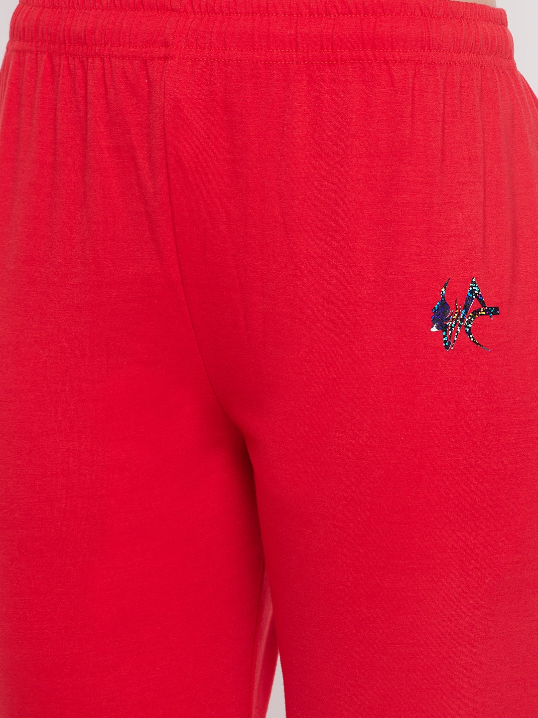 Red solid mid rise cotton track pants with elasticated waistband and pockets.