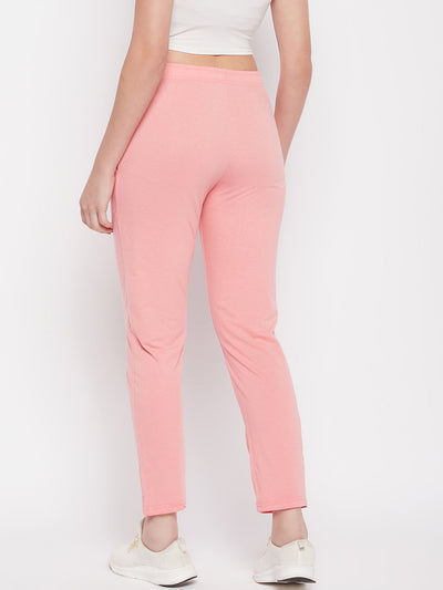 Peach solid mid rise cotton track pants with elasticated waistband and drawstring.