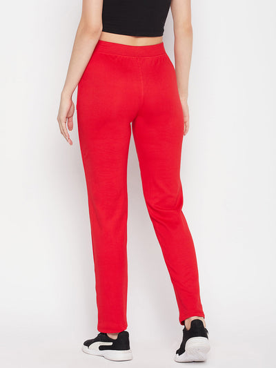 Red solid mid rise cotton trackpants with elasticated waistband and drawstring closure.