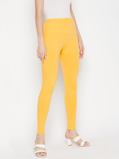 Yellow solid ankle length leggings with elasticated waistband.