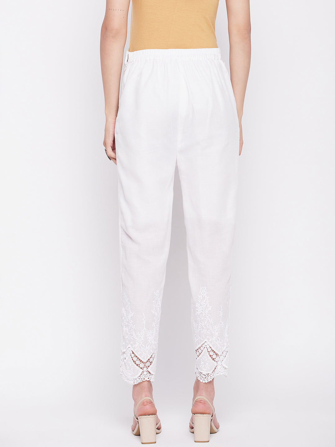 White solid cotton embroidered pant with ankle length and partially elasticated waistband.