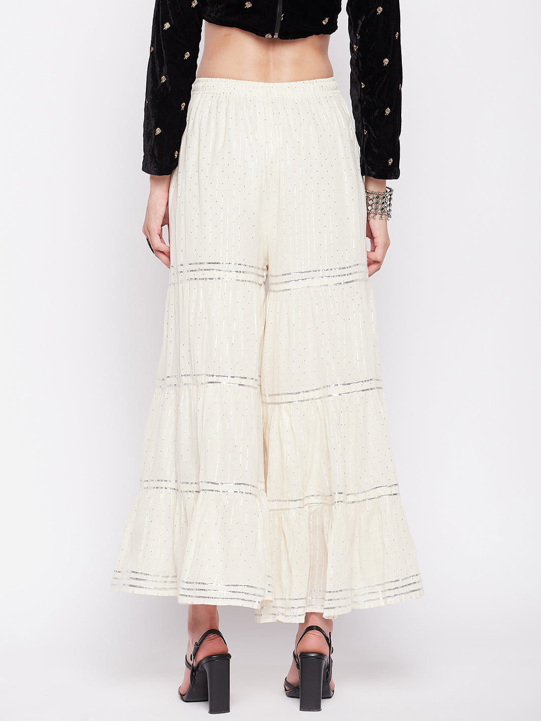 Off-White Silver Lurex Embellished Cotton Gharara with elastic waistband and flared hem.