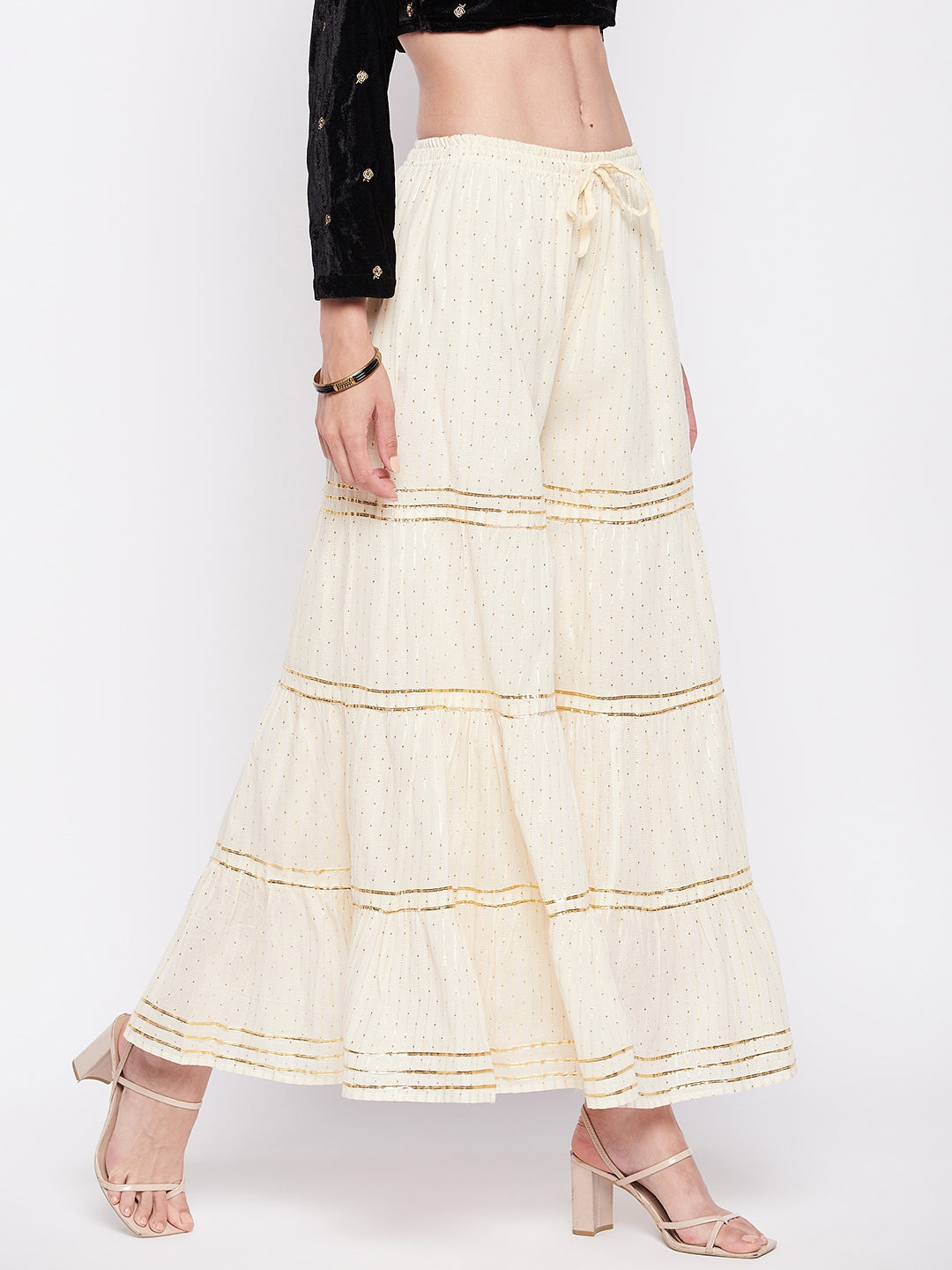 Off-White Golden Lurex Embellished Cotton Gharara with elastic waistband and flared hem.