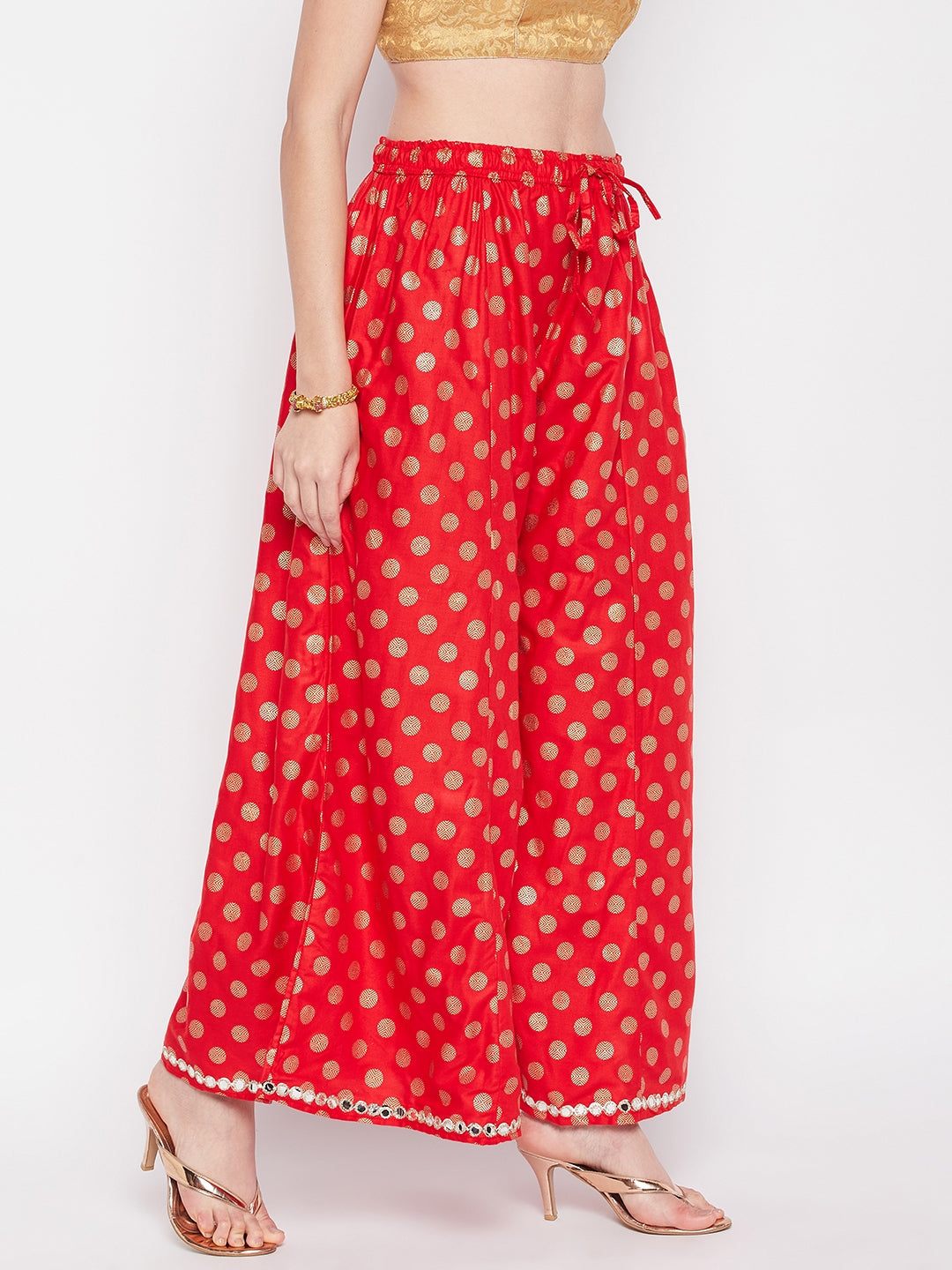 Red polka dot rayon sharara with embellished hem and elastic waistband.