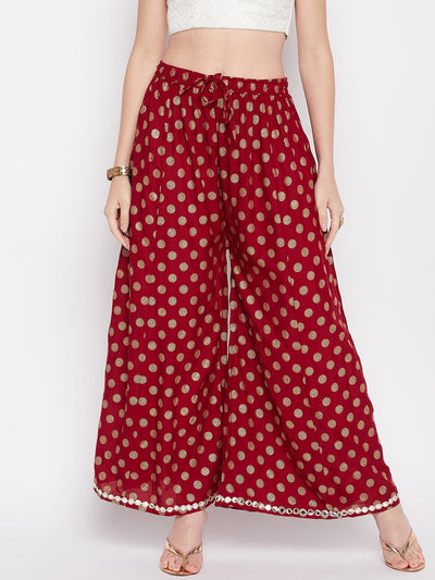 Maroon polka dot rayon sharara with embellished hem and elastic waistband.