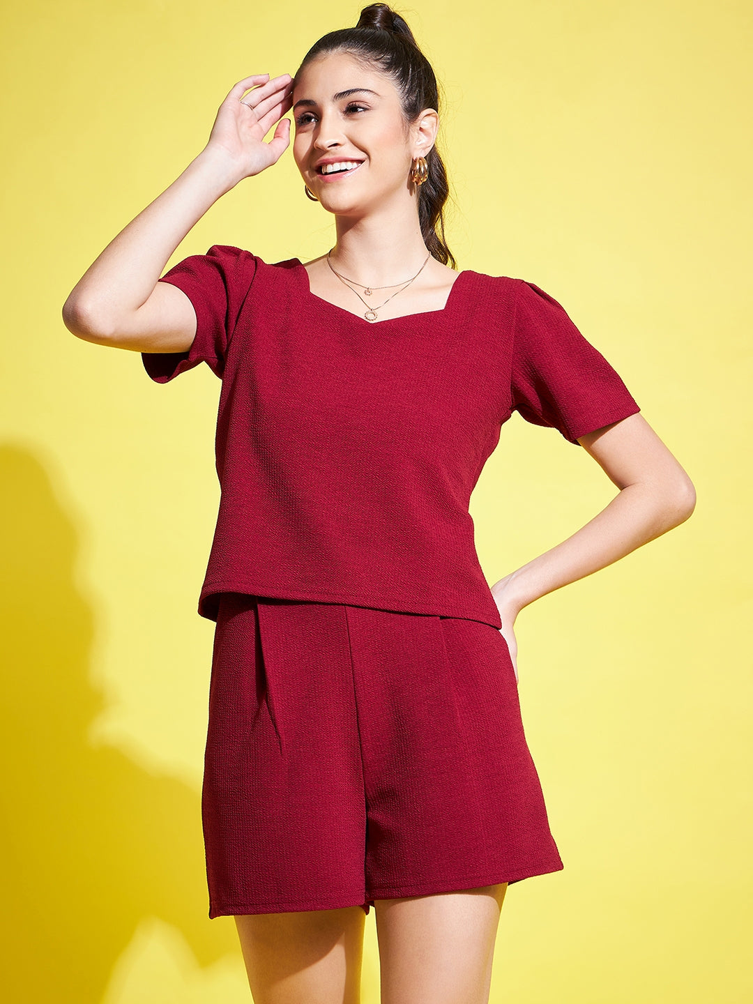 Maroon solid regular fit top, V-neck, half sleeves.