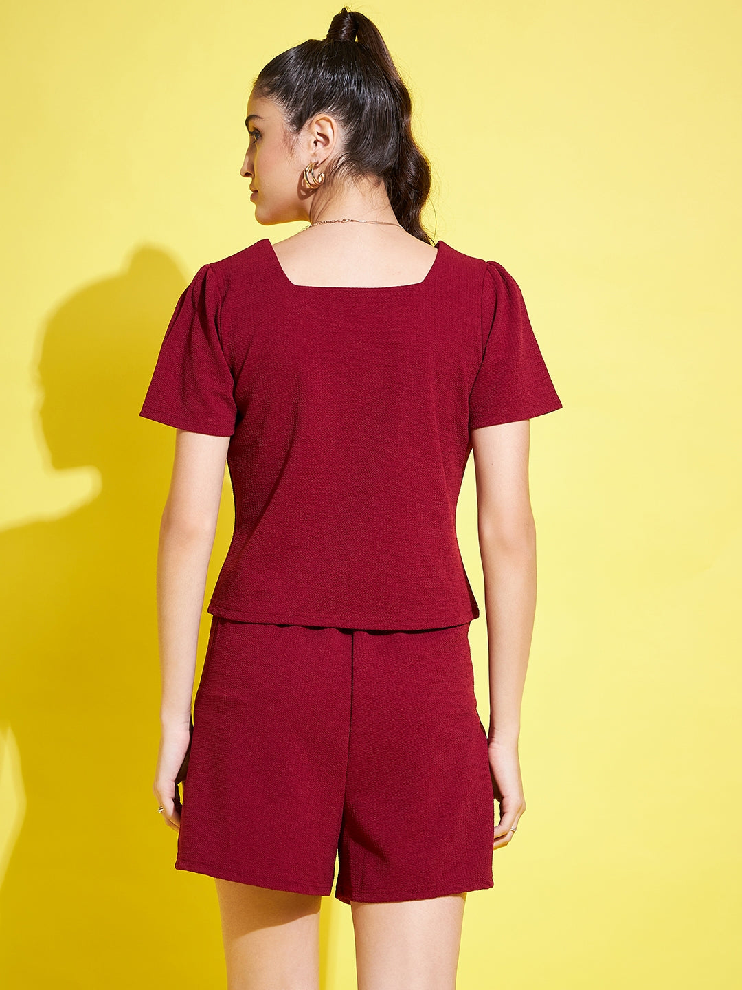 Maroon solid regular fit top with V-neck and half sleeves.