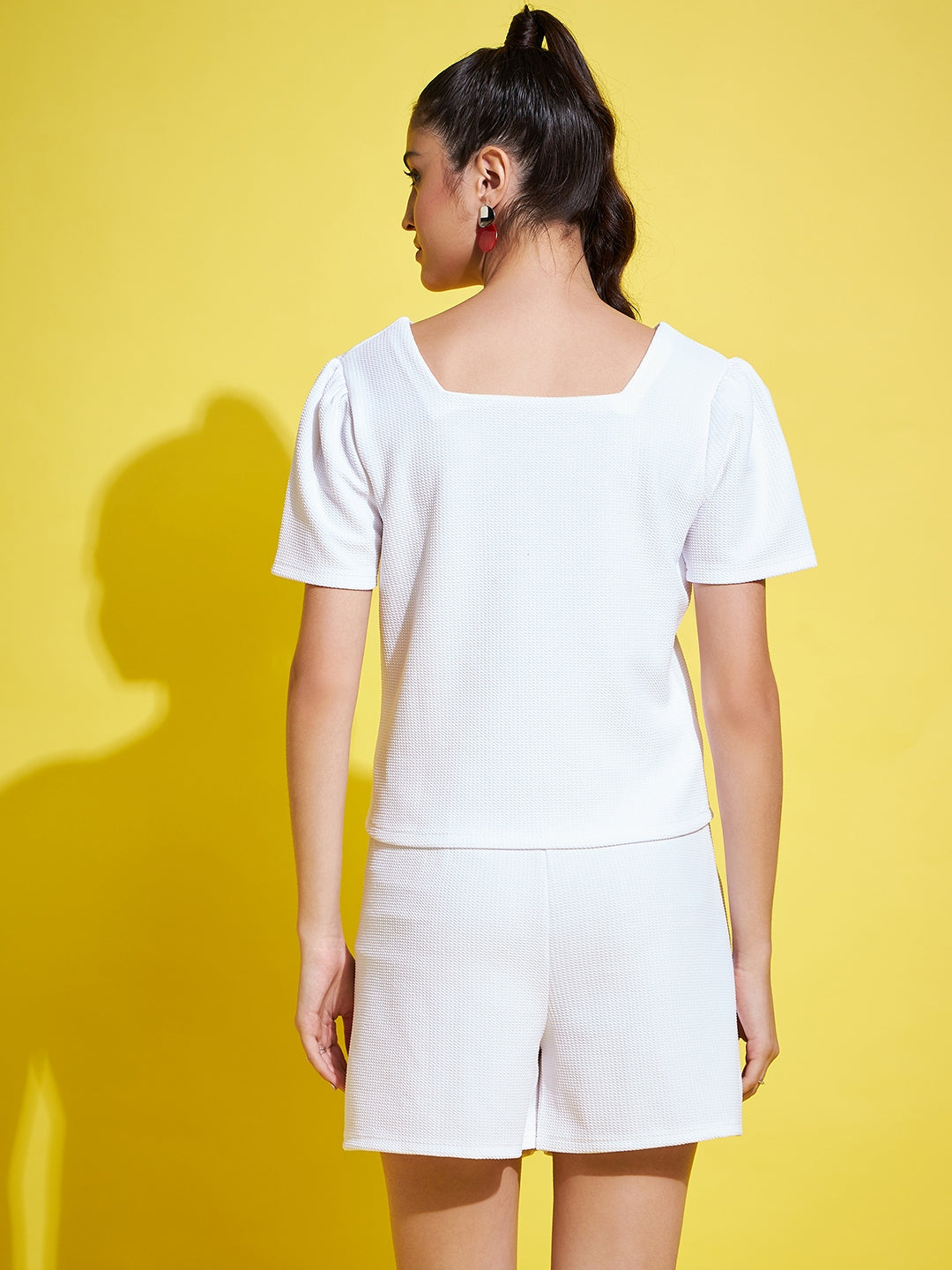 White solid regular fit top with V-neck and half sleeves.