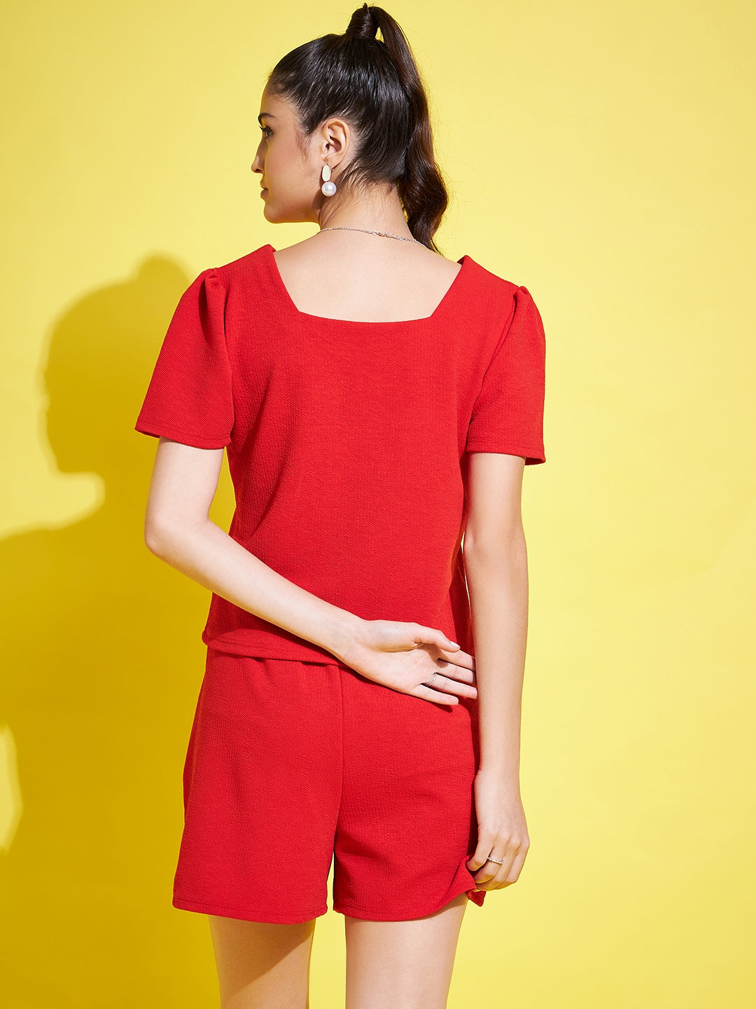 Red solid V-neck regular fit top with half sleeves.