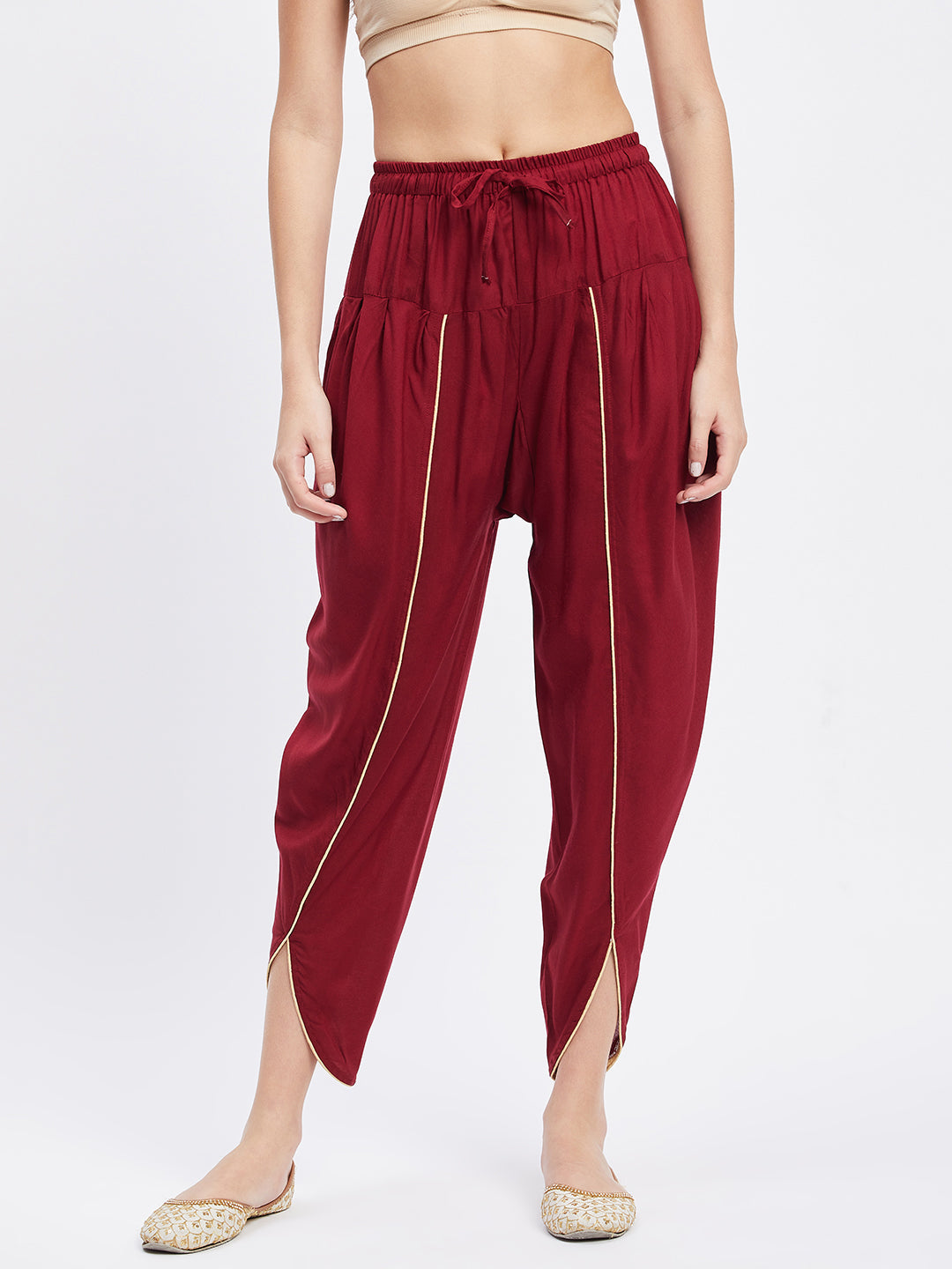 Maroon solid rayon tulip pant with elasticated waistband and side pocket.