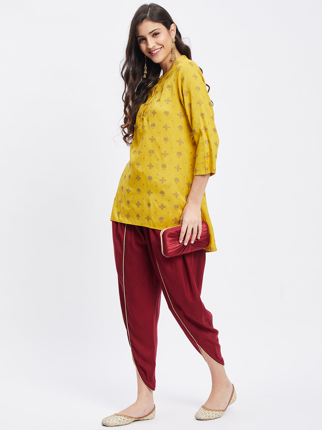 Maroon solid rayon tulip pant with elasticated waistband and drawstring.