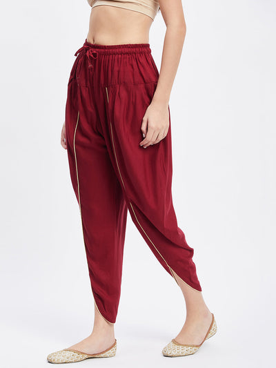 Maroon solid rayon tulip pant with elastic waistband and side pocket.