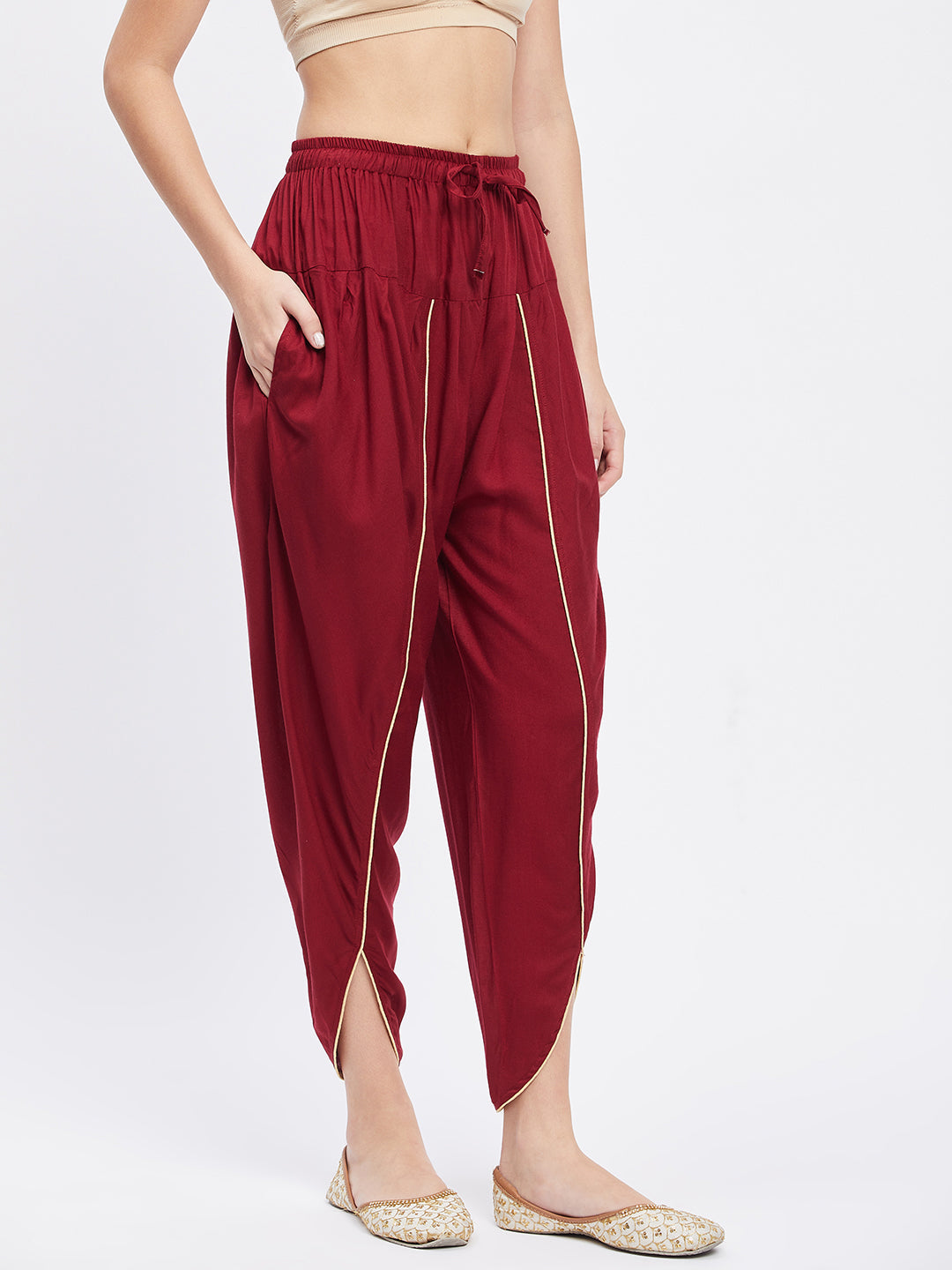 Maroon solid rayon tulip pant with elasticated waistband and side pocket.