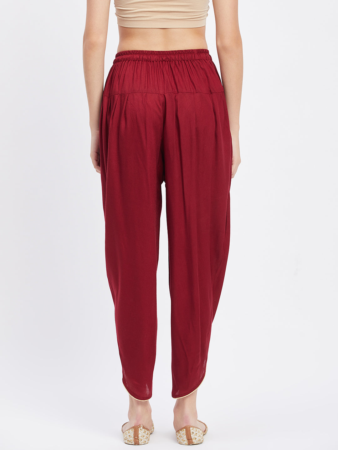 Maroon solid rayon tulip pant with elastic waist and side pocket.