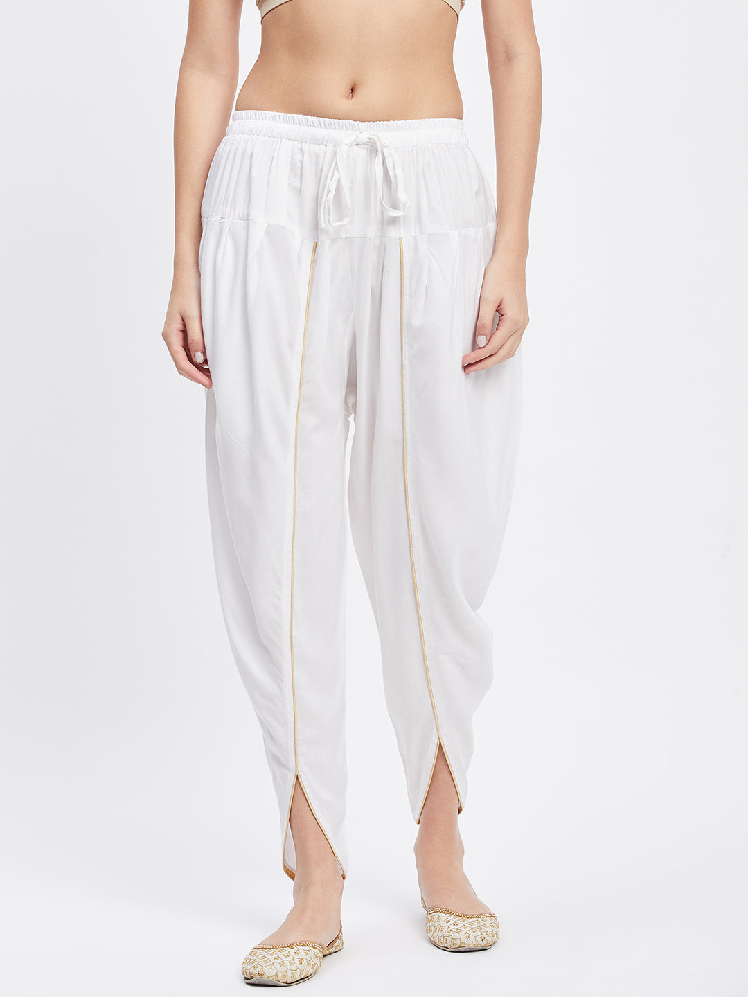 White solid rayon tulip pant with elasticated waistband and drawstring.