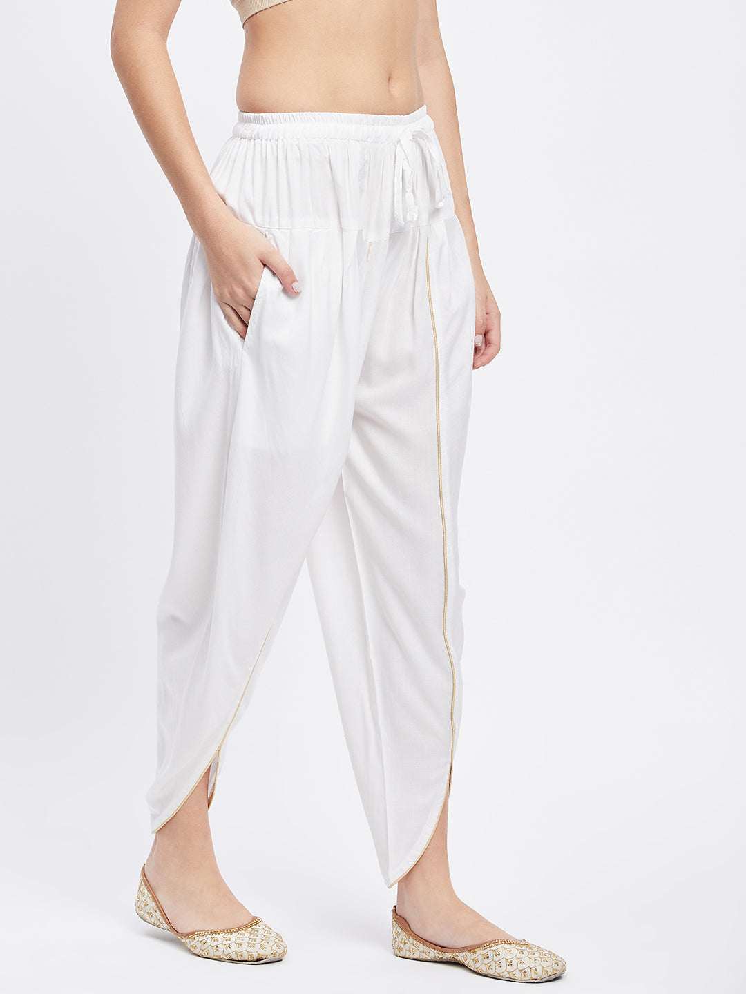 White solid rayon tulip pant with elasticated waistband and drawstring.