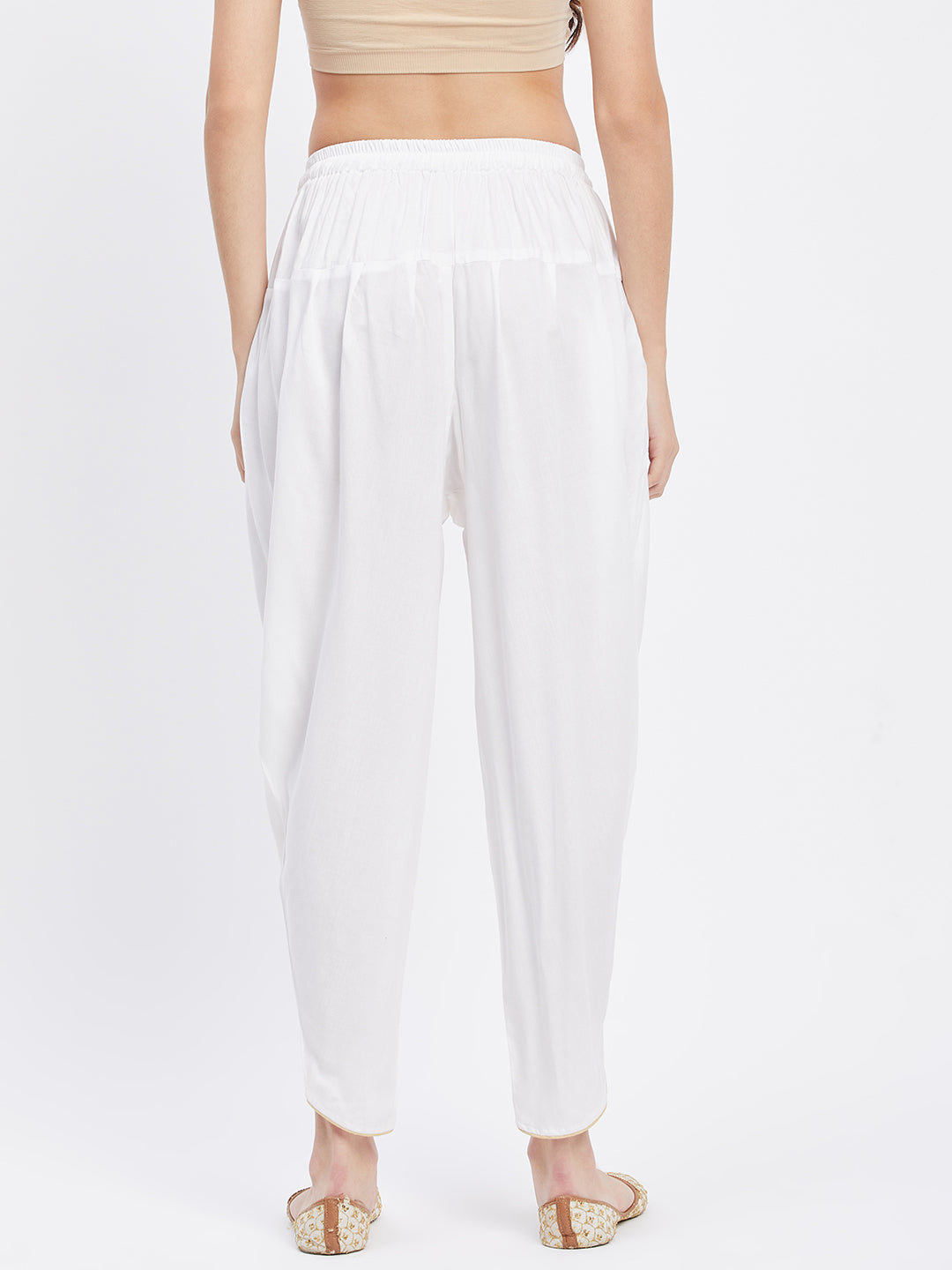 White solid rayon tulip pant with elasticated waistband and side pocket.